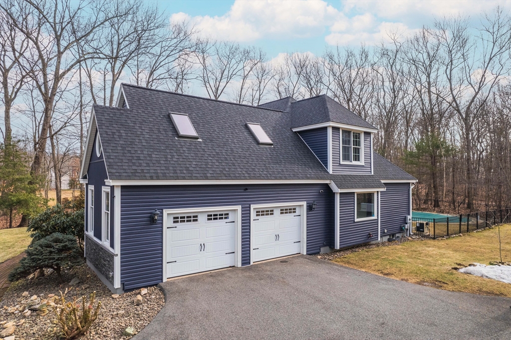 11 Pope Road Atkinson, NH 03811 - Photo 2 of 42 a front view of a house with a yard and garage