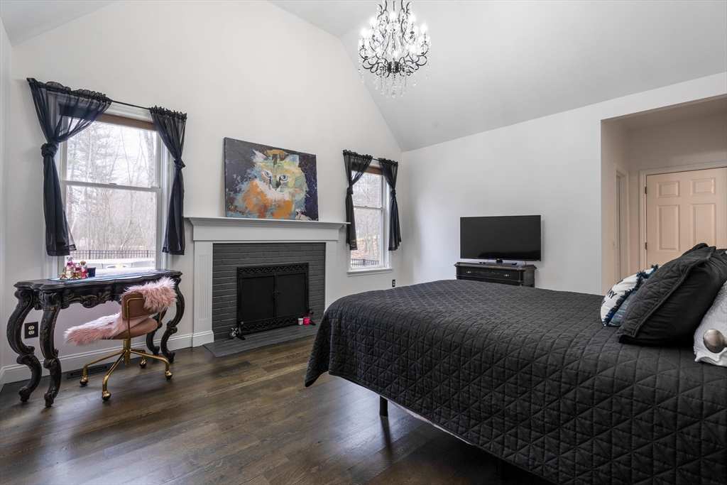 11 Pope Road Atkinson, NH 03811 - Photo 24 of 42 a bedroom with a bed and a fireplace