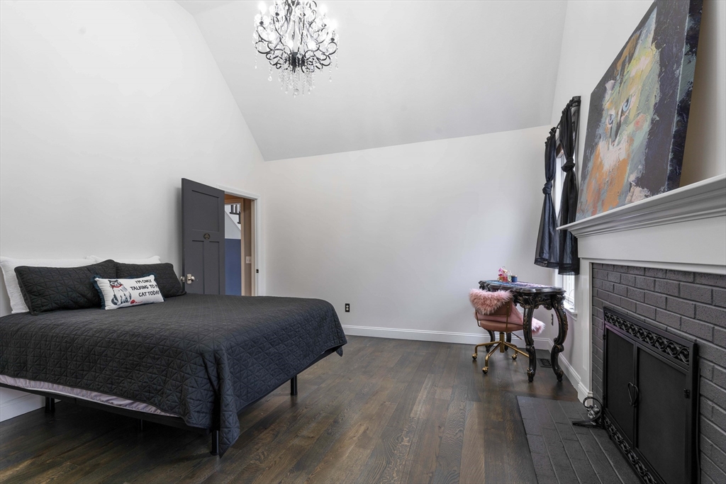 11 Pope Road Atkinson, NH 03811 - Photo 25 of 42 a bedroom with a bed and a fireplace