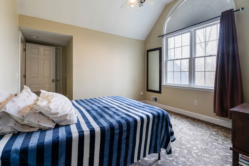 11 Pope Road Atkinson, NH 03811 - Photo 30 of 42 a bedroom with a bed and wooden floor