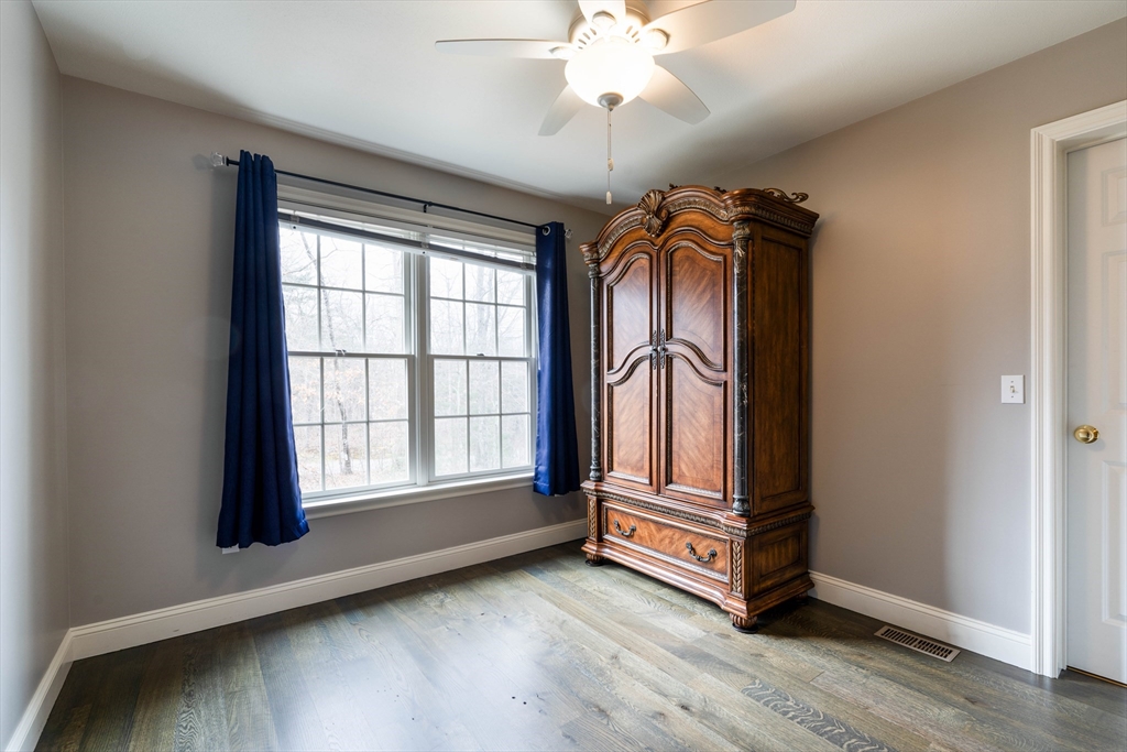 11 Pope Road Atkinson, NH 03811 - Photo 33 of 42 an empty room with wooden floor and windows