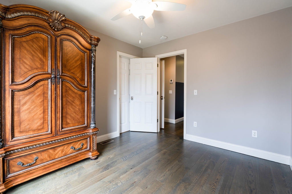 11 Pope Road Atkinson, NH 03811 - Photo 34 of 42 an empty room with wooden floor fan and windows