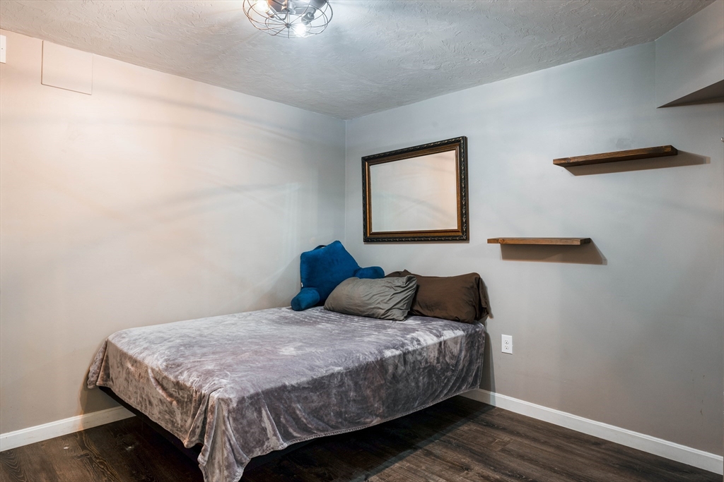 11 Pope Road Atkinson, NH 03811 - Photo 42 of 42 a bedroom with a bed and wooden floor