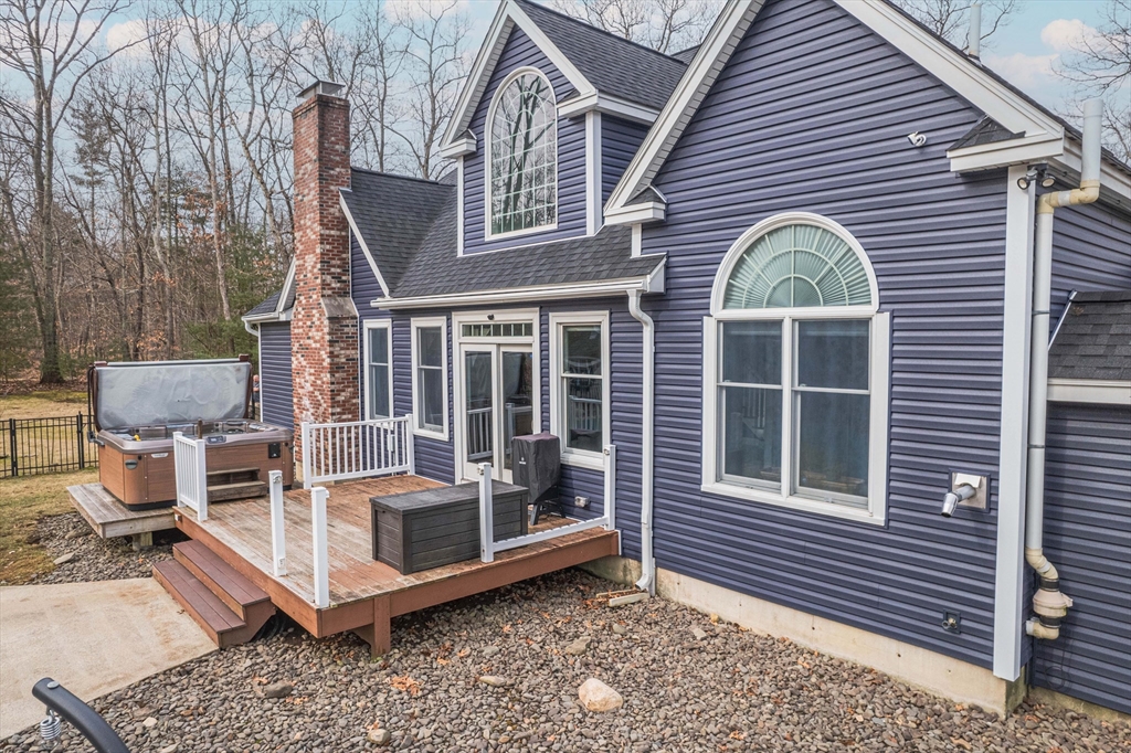 11 Pope Road Atkinson, NH 03811 - Photo 5 of 42 a view of a house with a large window and wooden fence