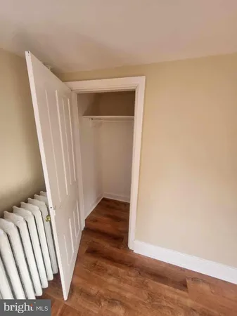 a kitchen with a sink and wooden floor
