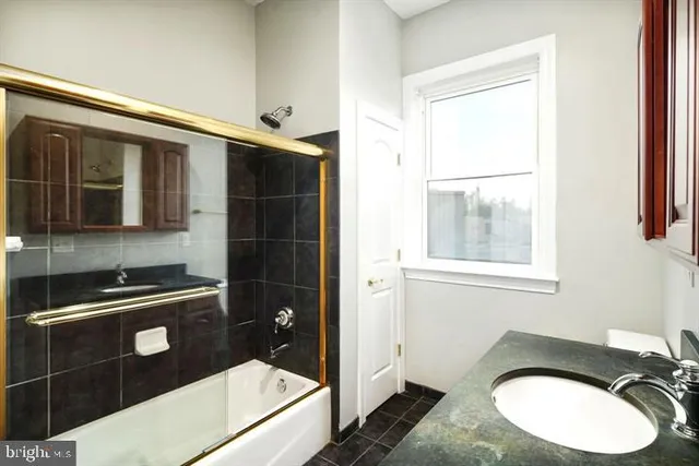 a bathroom with a sink a toilet and a shower
