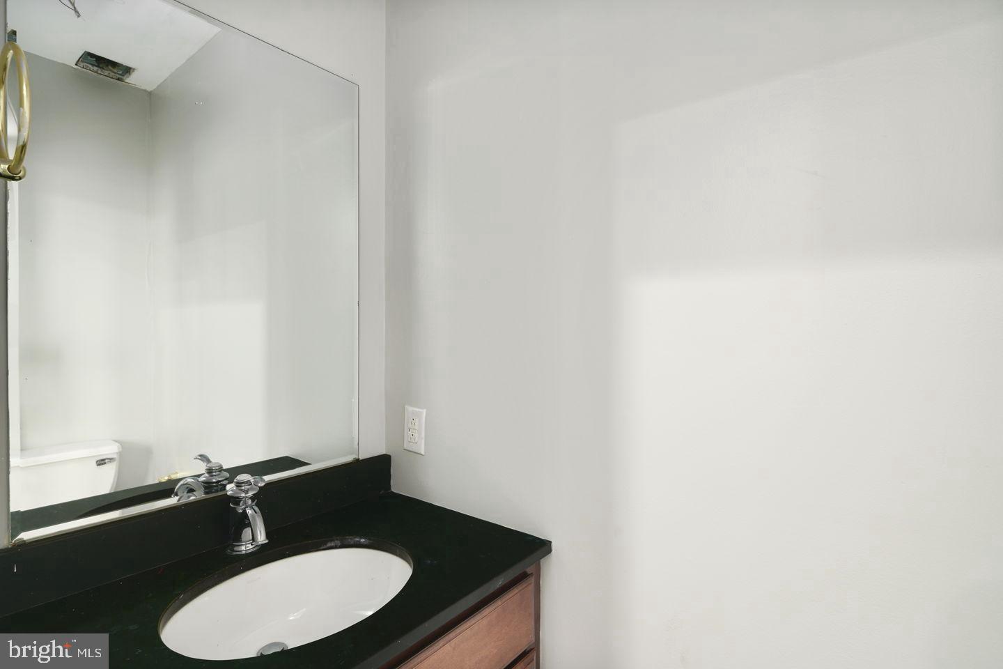 3933 Lancaster Avenue, Unit A Philadelphia, PA 19104 - Photo 10 of 22 a bathroom with a sink and a mirror