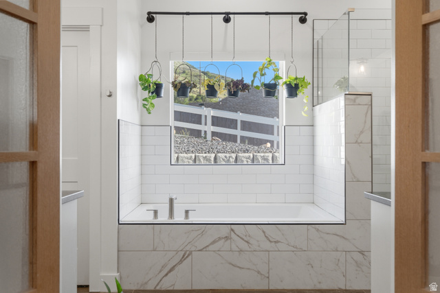 2013 South 100 West Perry, UT 84302 - Photo 26 of 49 Soaking tub with subway tile surround, accented by a marble-look tile base