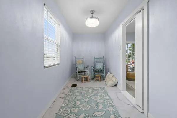 a living room with furniture and a floor to ceiling window