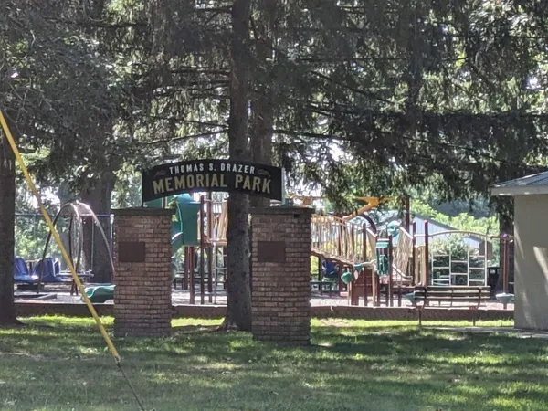 a view of a park with iron fence