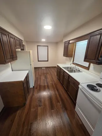 a kitchen with sink and cabinets