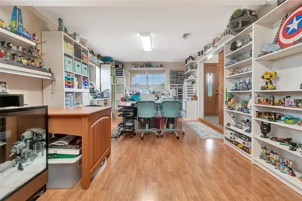 a dining room with furniture and wooden floor