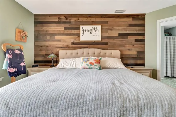 a bedroom with a bed and a window