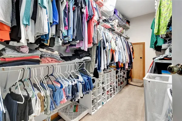a view of walk in closet with clothes