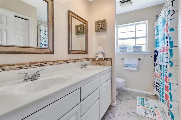 a bathroom with a sink toilet and a mirror