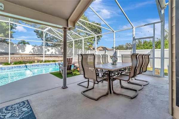 a view of an outdoor dining space with a table and chairs
