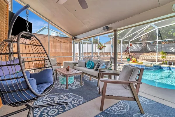 a living room with furniture and a floor to ceiling window