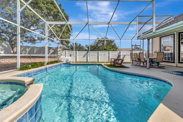 a view of a backyard with swimming pool