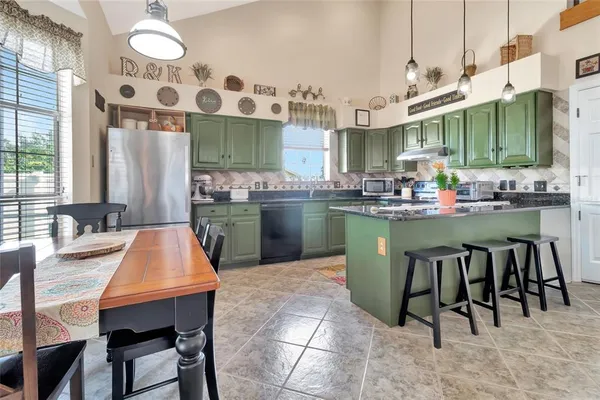 a kitchen with a table chairs sink and cabinets