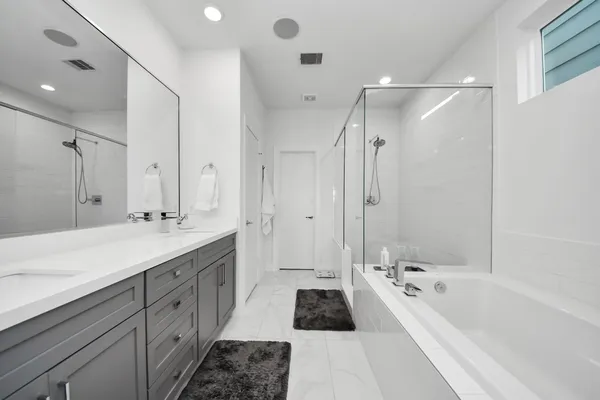a bedroom with a bed and a dresser next to a window