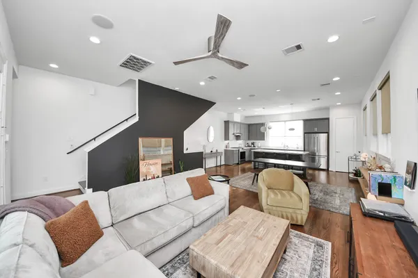 a living room with furniture and kitchen view