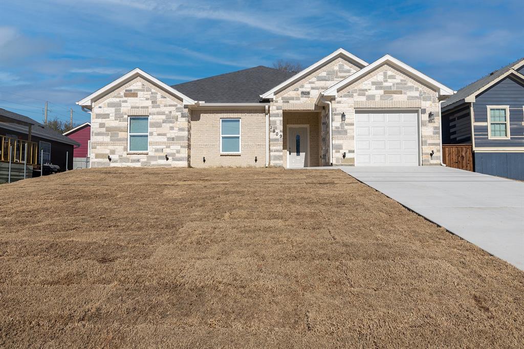 a front view of a house with a garden and entryway