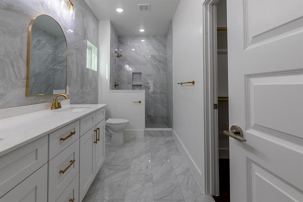 2809 Gooch Street Dallas, TX 75241 - Photo 14 of 19 a bathroom with a double vanity sink toilet and shower