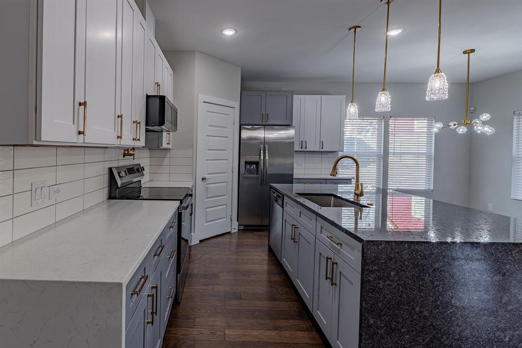 2809 Gooch Street Dallas, TX 75241 - Photo 6 of 19 a kitchen with stainless steel appliances granite countertop a sink a stove and a refrigerator