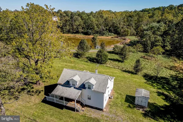 an aerial view of a house with a yard and lake view