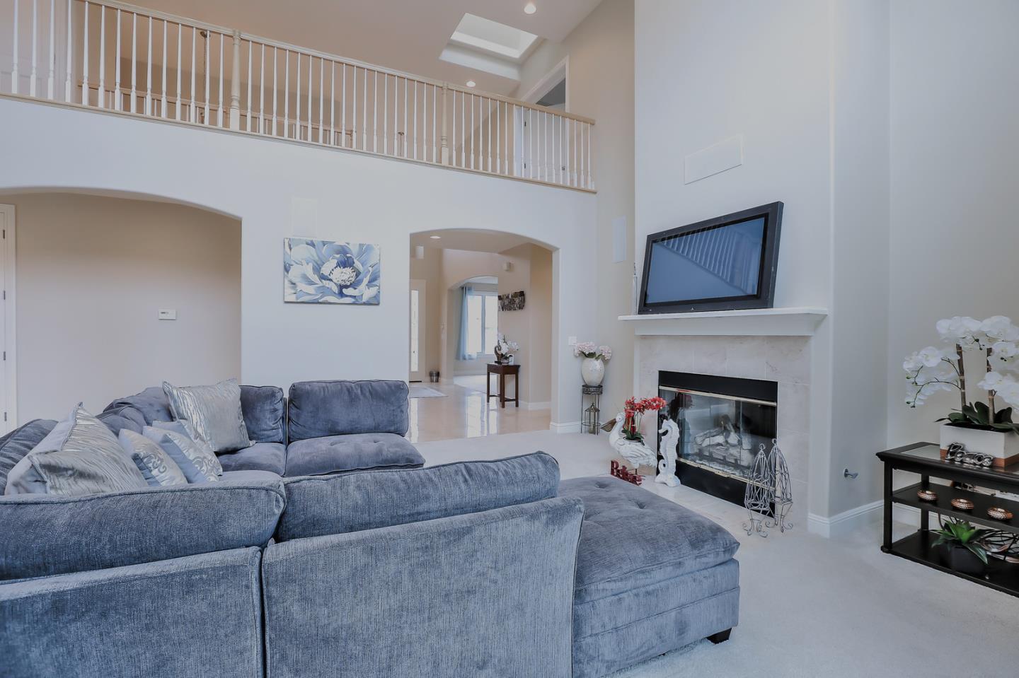 135 Cypress Point Road Half Moon Bay, CA 94019 - Photo 35 of 80 a living room with furniture a flat screen tv and a fireplace