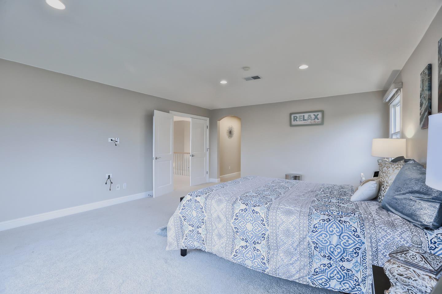 135 Cypress Point Road Half Moon Bay, CA 94019 - Photo 48 of 80 a bedroom with a large bed and a large mirror