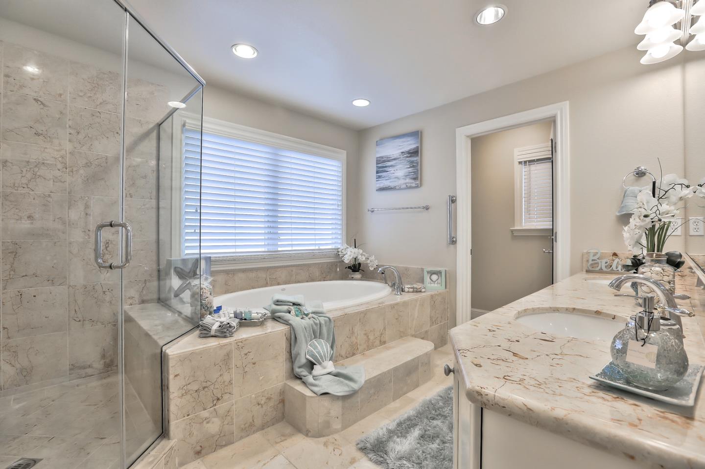 135 Cypress Point Road Half Moon Bay, CA 94019 - Photo 51 of 80 a bathroom with a granite countertop sink and a bathtub