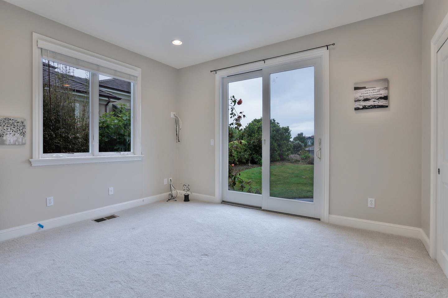 135 Cypress Point Road Half Moon Bay, CA 94019 - Photo 61 of 80 a view of an empty room with wooden floor and a window