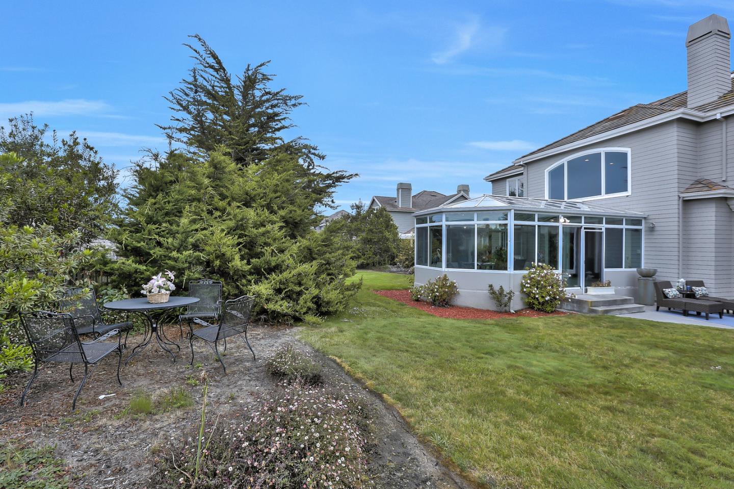 135 Cypress Point Road Half Moon Bay, CA 94019 - Photo 70 of 80 a view of a house with backyard porch and sitting area
