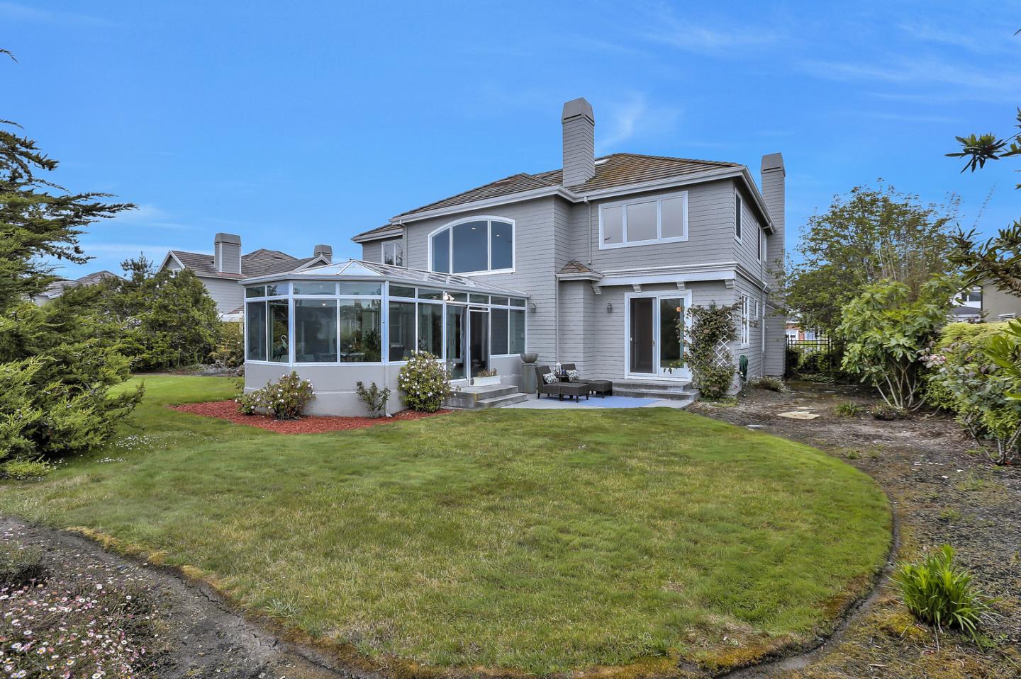 135 Cypress Point Road Half Moon Bay, CA 94019 - Photo 71 of 80 a front view of a house with a yard table and chairs