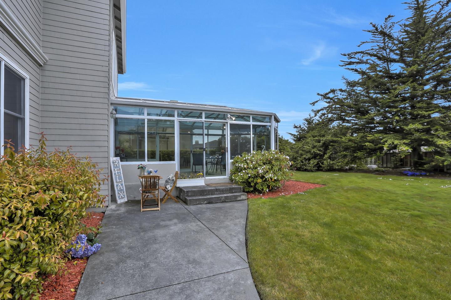 135 Cypress Point Road Half Moon Bay, CA 94019 - Photo 75 of 80 a view of a house with backyard sitting area and garden