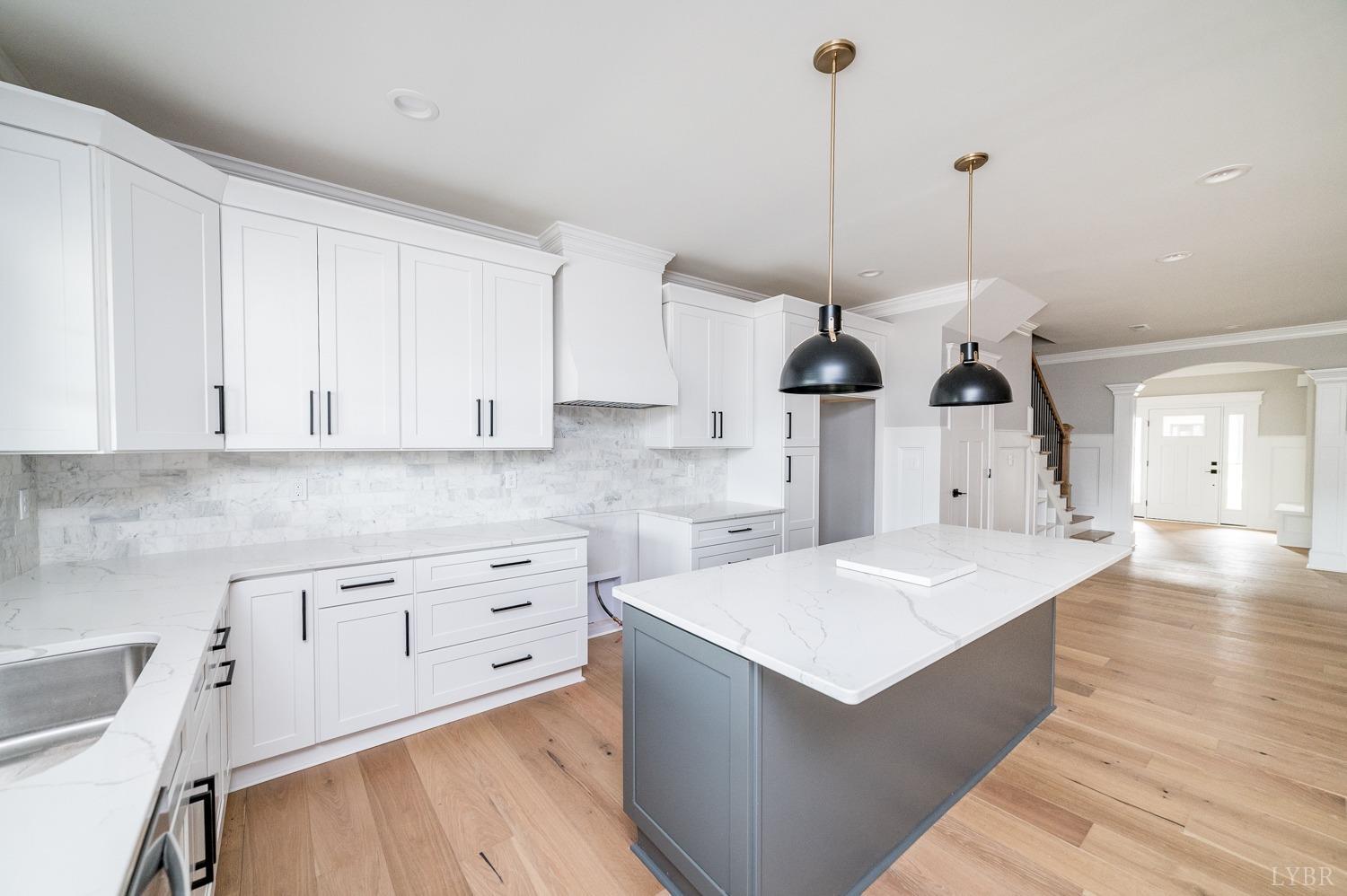 1073 South Westyn Loop Forest, VA 24551 - Photo 16 of 66 a kitchen with white cabinets sink and stove