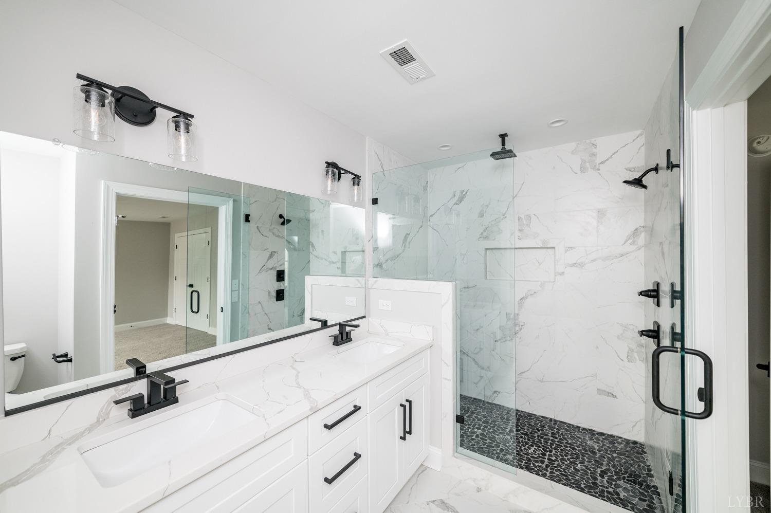 1073 South Westyn Loop Forest, VA 24551 - Photo 23 of 66 a bathroom with a shower sink and mirror