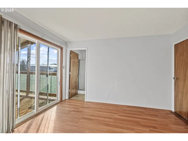 a view of an empty room and wooden floor