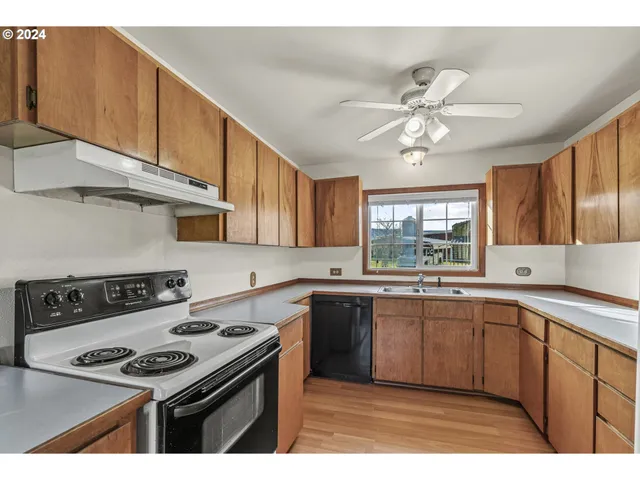 a kitchen with a stove a sink and cabinets
