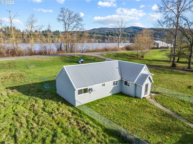 an aerial view of a house with garden space and street view