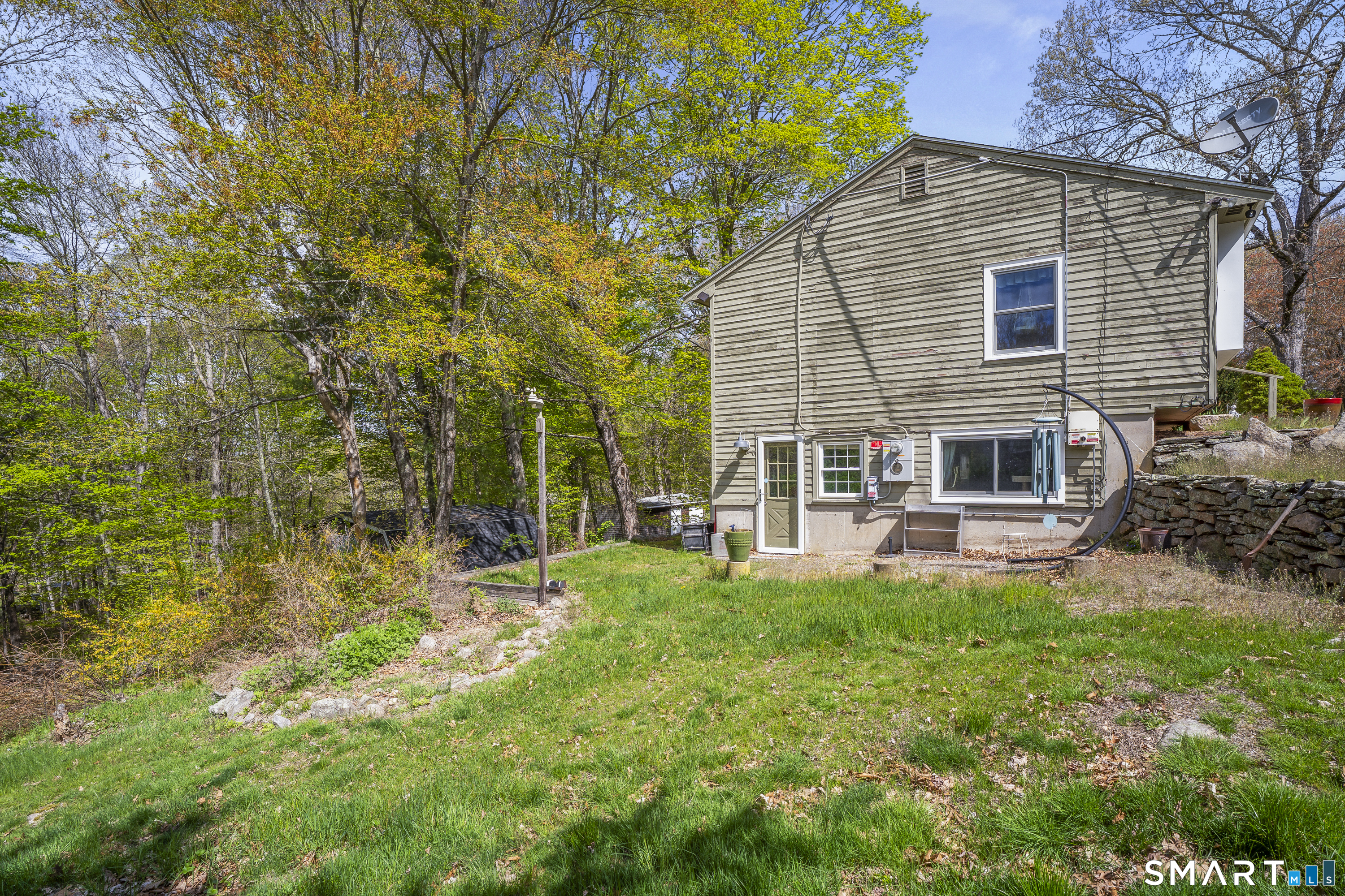 239 Haley Road Ledyard, CT 06339 - Photo 37 of 40 a backyard of a house with table and chairs