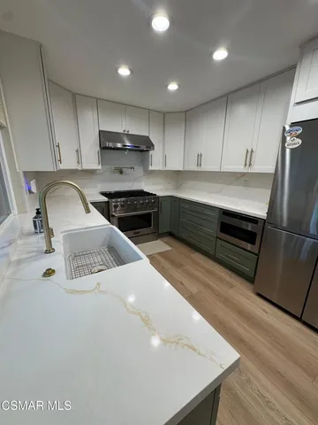 a kitchen with sink refrigerator and stove