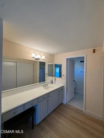 a spacious bathroom with a sink and a mirror
