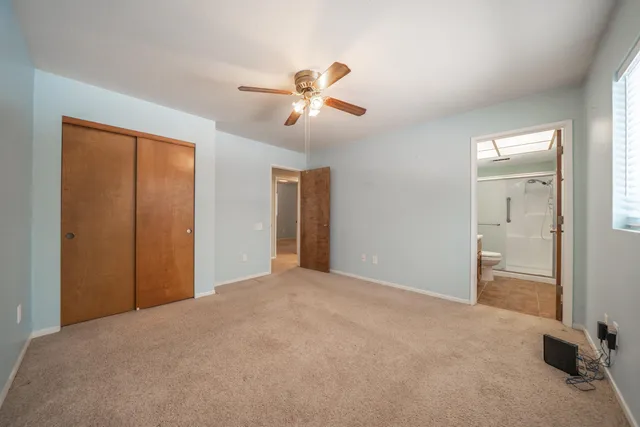 a view of empty room with ceiling fan