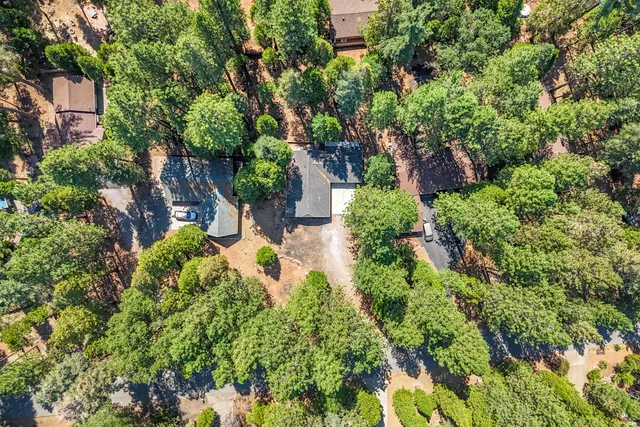 an aerial view of a house with a yard