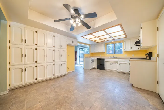 a large white kitchen with white cabinets