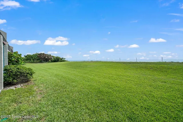 a view of yard with swimming pool and green space