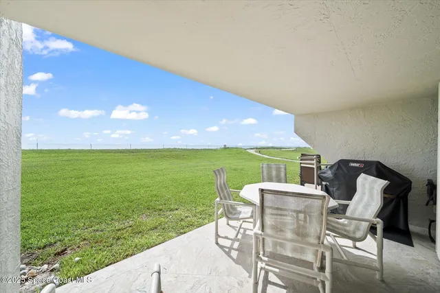 a view of an chairs and table in the garden