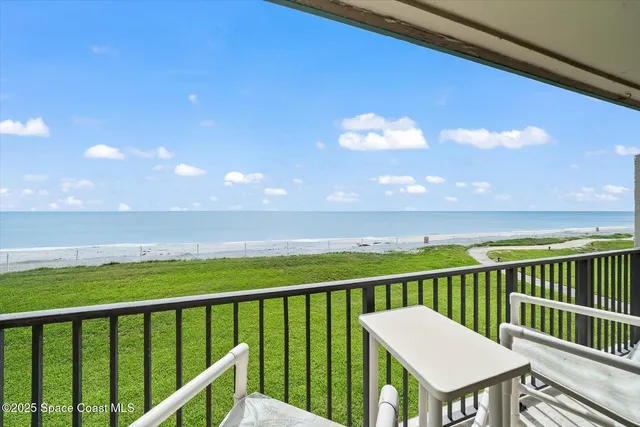 a view of a balcony with chair and table